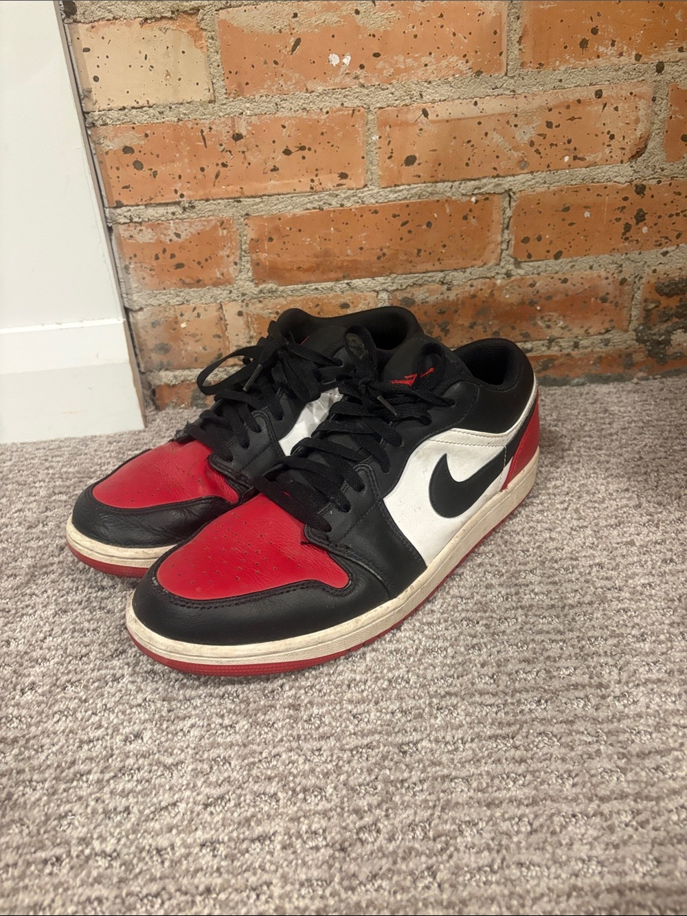 Nike Air Jordan 1 Low Sneakers in Black, Red, and White